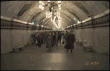 [Commuters arrive in a metro station]